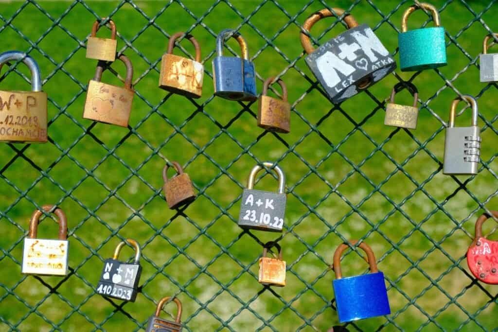 Boundaries & Relationships 1 love padlocks on mesh fence symbolizing connection and protection. Relationship Boundaries, Protection.