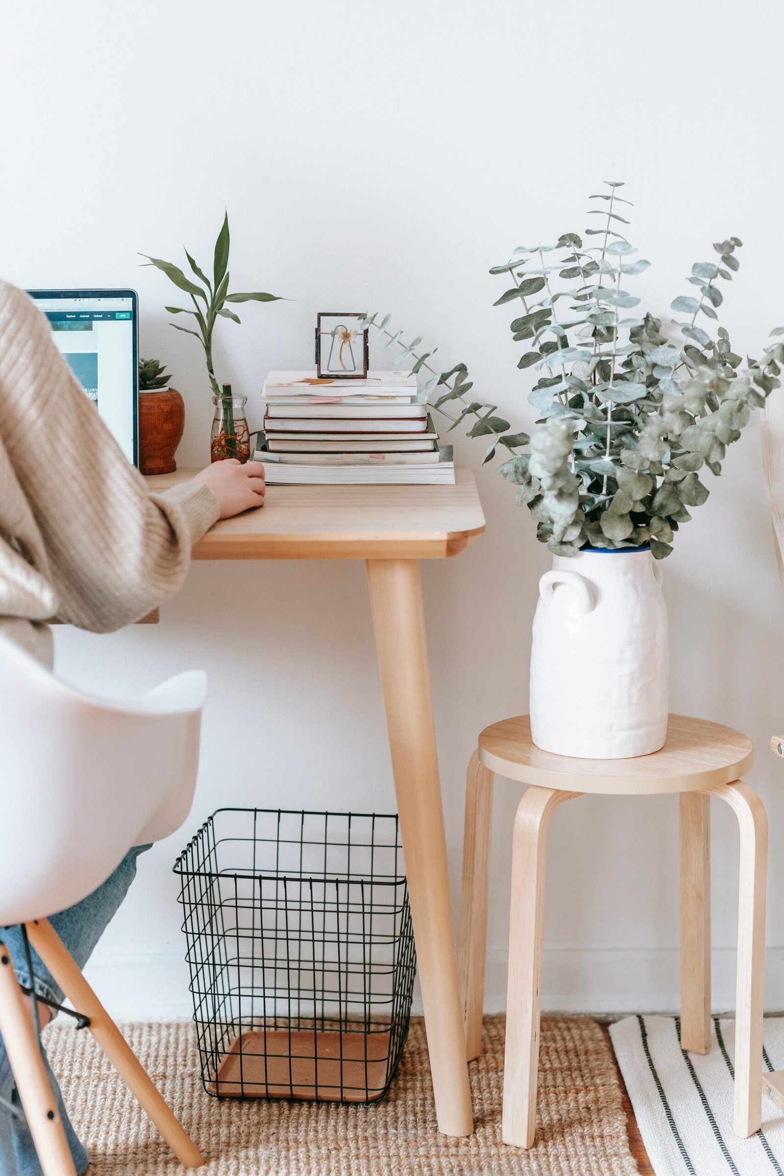About 2 Cozy workspace with a laptop, books, and plants, promoting a relaxed, creative atmosphere.